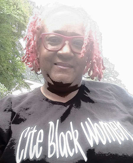 Psyche Williams-Forson wearing glasses and a black shirt that reads, “Cite Black Women.”