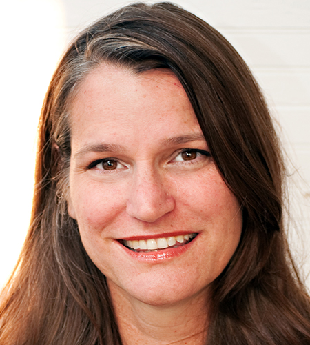 A smiling, brown-haired woman.