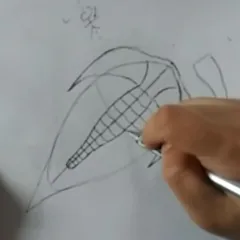 A hand holding a pen and drawing a trilobite fossil on white paper.