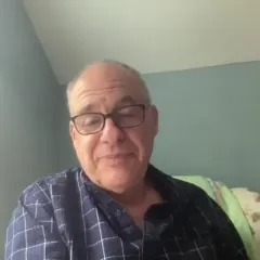 Food journalist Mark Bittman, a light-skinned man wearing glasses and a blue and white checked shirt
