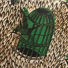 a bird flying out of a cage