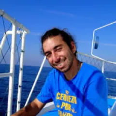 A man smiling on a boat
