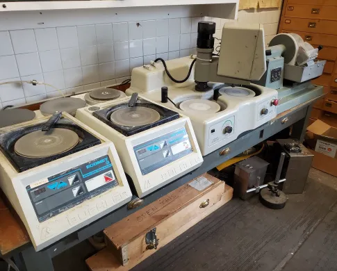 Four grinding and polishing wheels in a lab