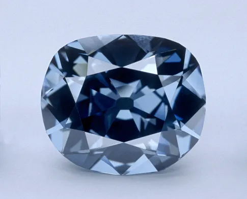 The dark-blue Hope Diamond outside its setting on a light blue background