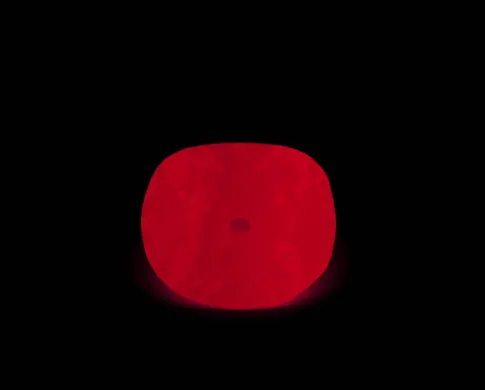 The Hope Diamond under UV light glows red against a dark background