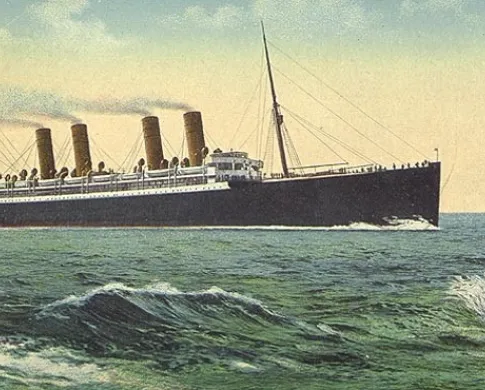 An ocean liner with four smokestacks travels on a green-blue ocean