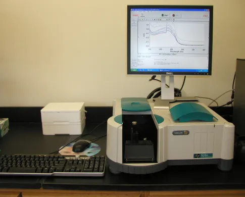 White and teal spectrophotometer with monitor and keyboard