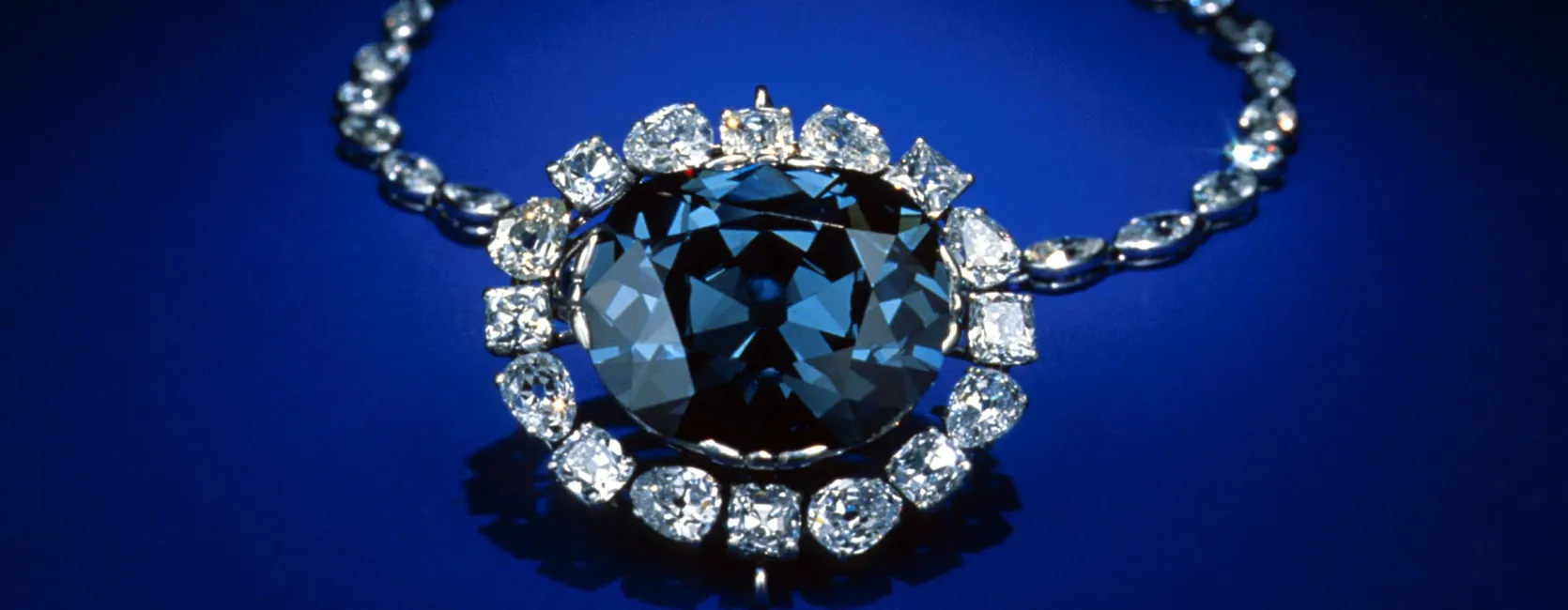A blue diamond necklace on a blue background