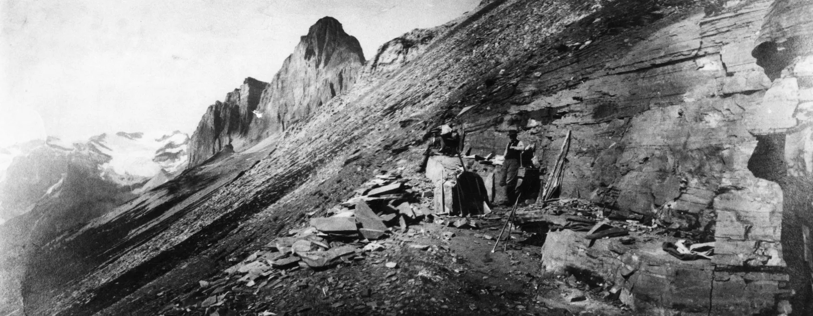 rocky outcrop on a hillside with several people