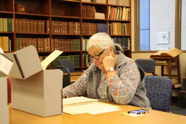 Woman looking at archival material.