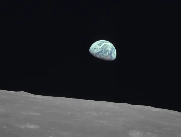 Planet Earth seen from space with the cratered surface of the Moon in the foreground