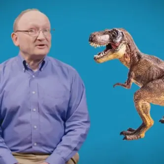 Dr. Hans Sues in front of a blue screen next to a dinosaur. 