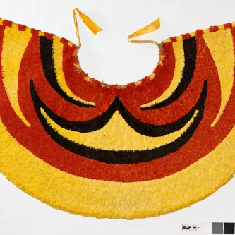 Red, gold, and black cape made from Hawaiian bird feathers