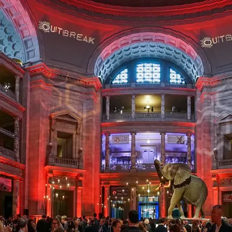The rotunda transformed with red lighting for a private Outbreak reception