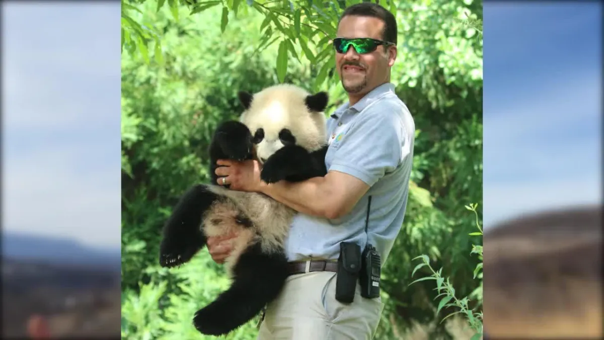 Juan Rodriguez holding a Giant panda.