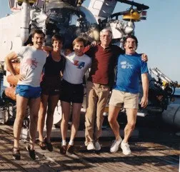 A group of scientists gathered around a submersible