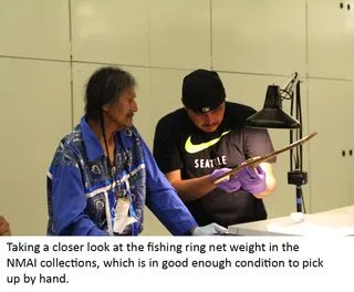 Two Wanapum members examining a fishing ring net weight with light.