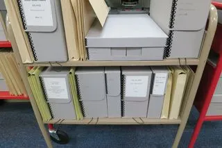 Archival boxes on a rolling cart.