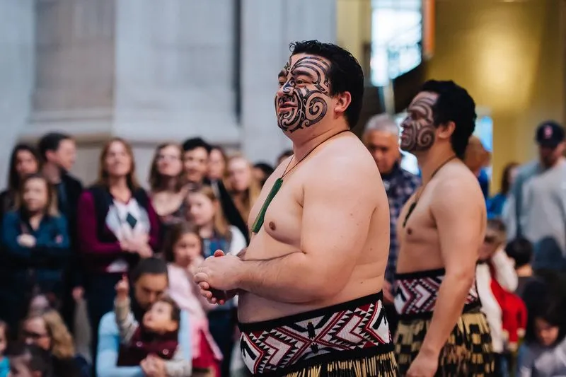 Māori man talking to a crowd in the rotunda of NMNH.