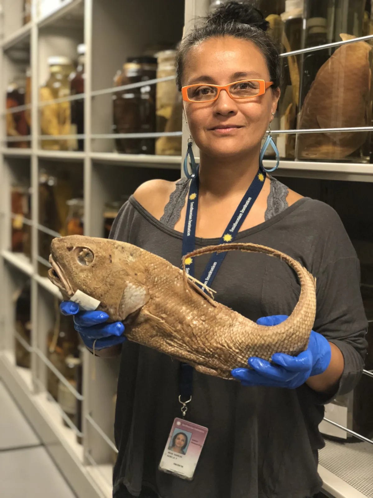 Woman holding a preserved fish specimen