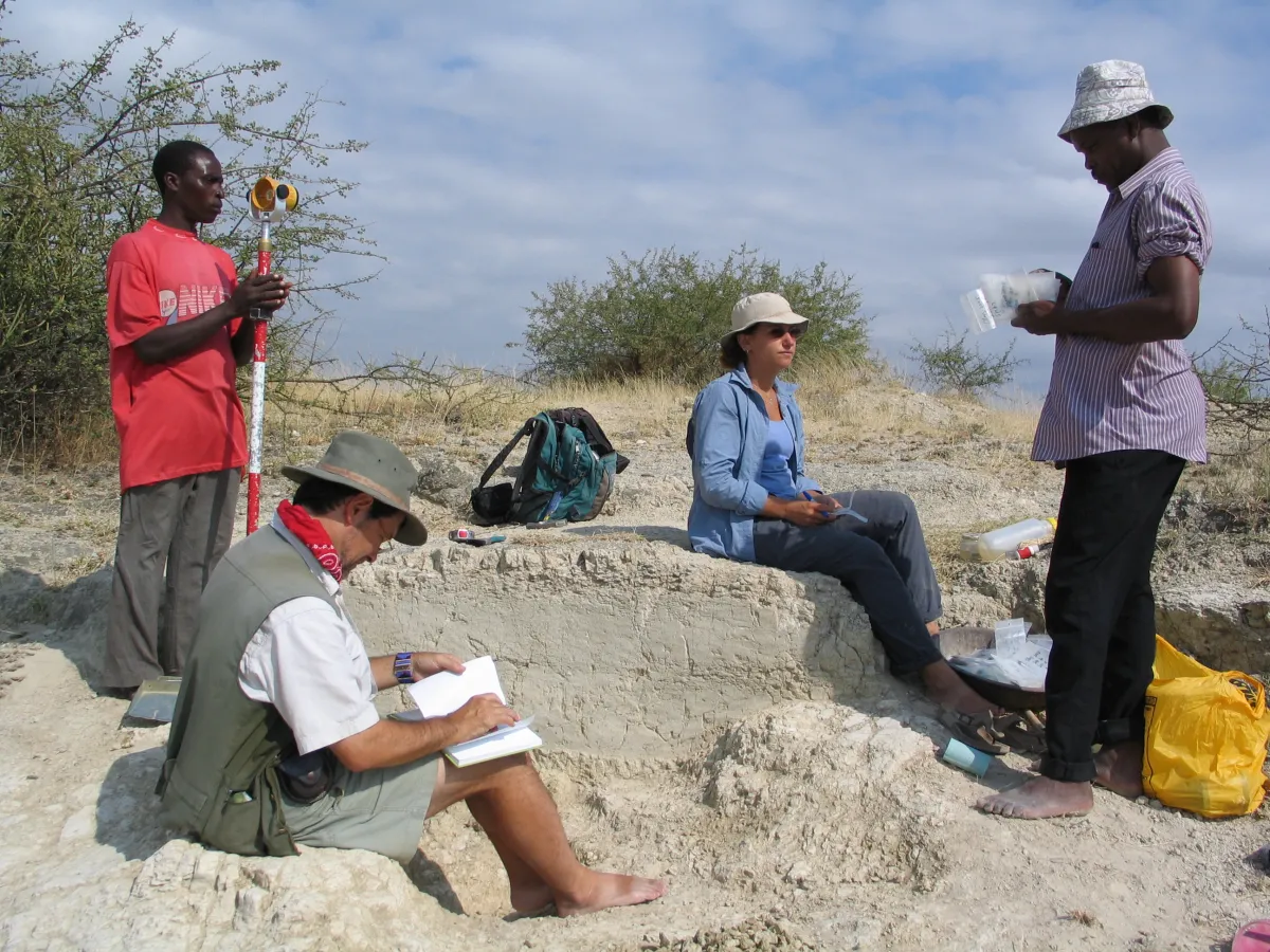 Briana Pobiner at Olorgesailie excavation sitting down among her colleagues