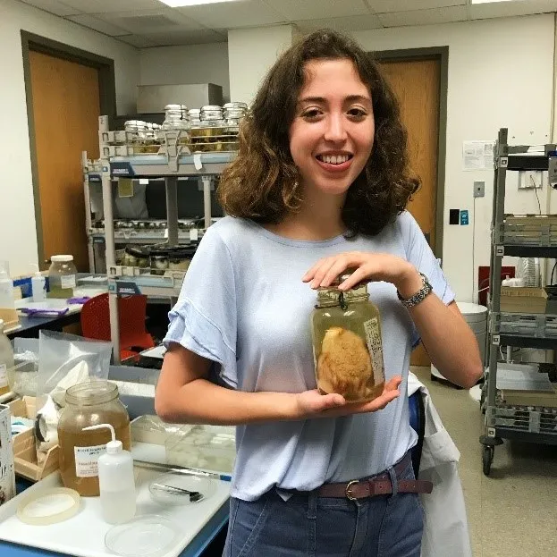Intern Charlotte Adamo with invertebrate specimen jar