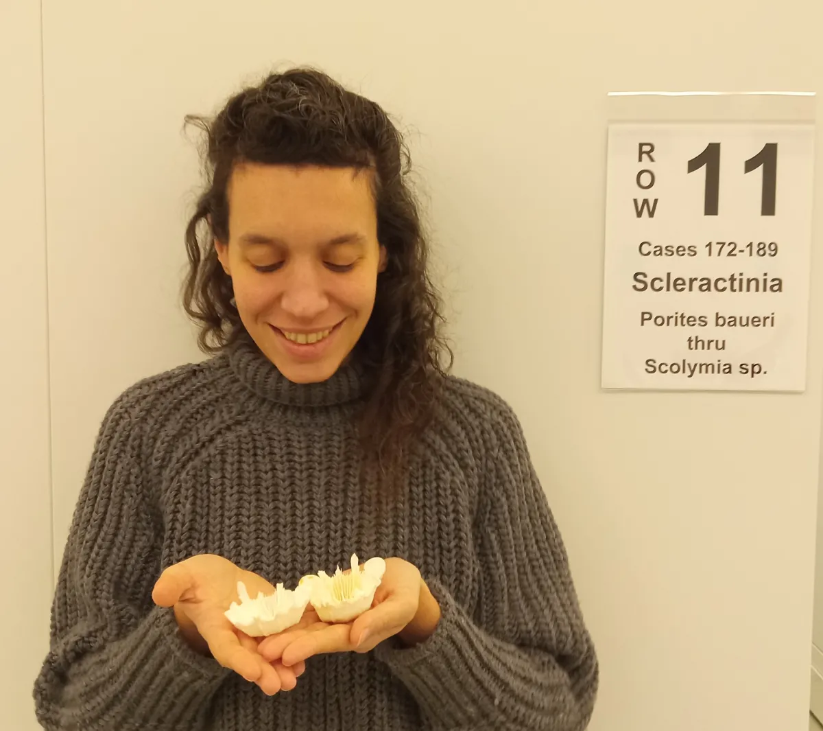 Claudia holding up a dried coral specimen