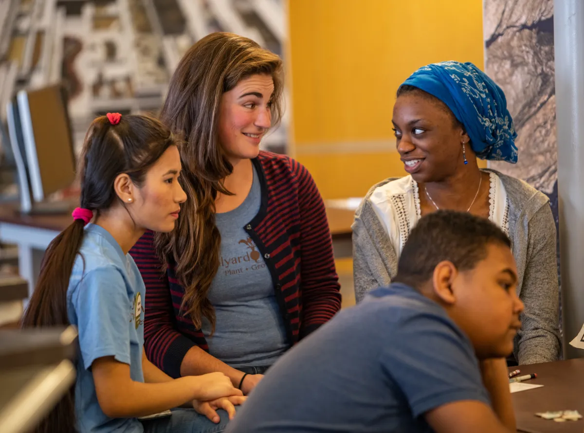 Three people interact at a conversation station at the 2019 Earth Optimism Teen Event.
