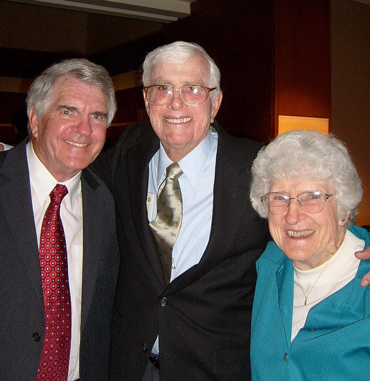 Two men and one woman smiling