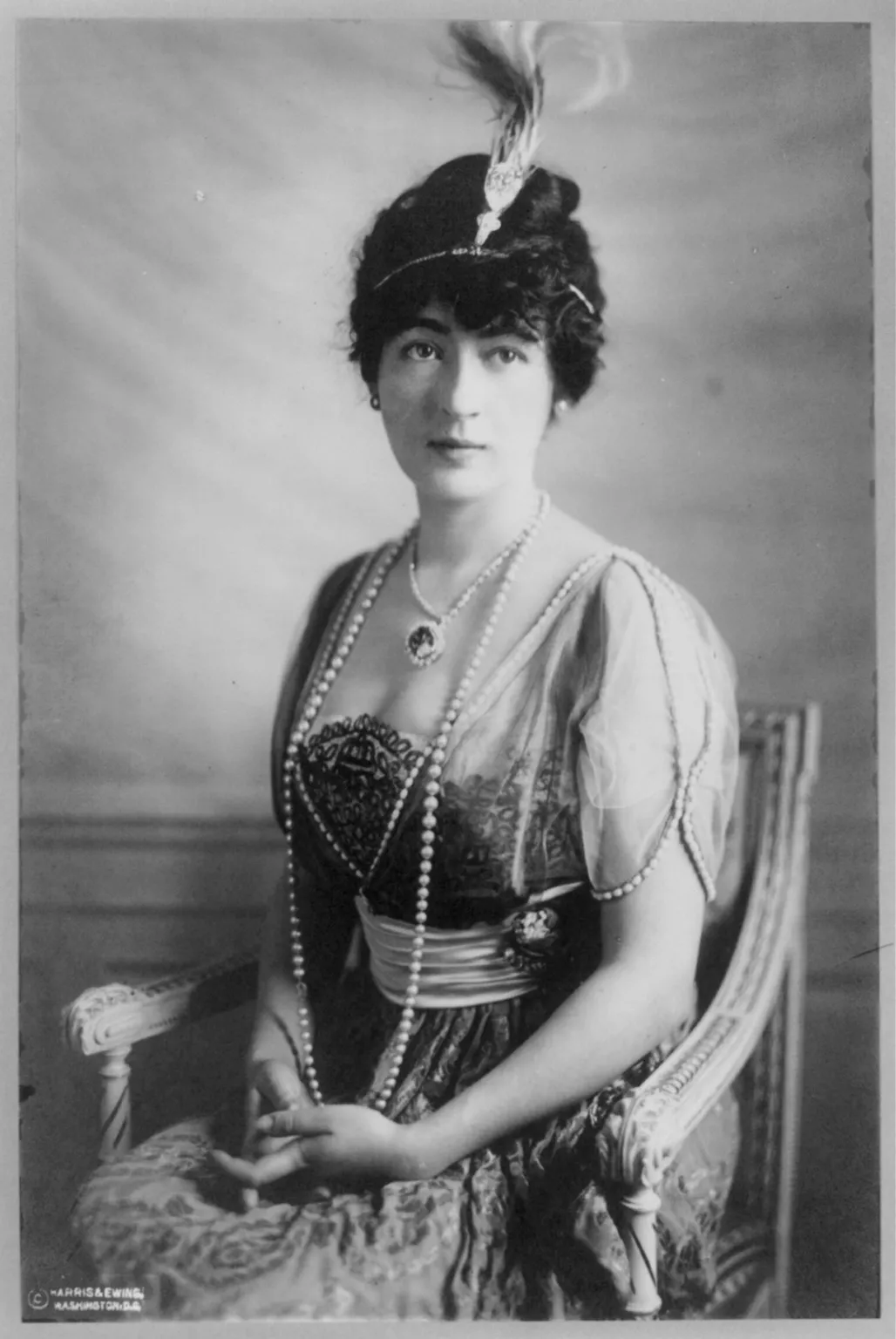 A light-skinned woman with dark hair wearing pearls and the Hope Diamond