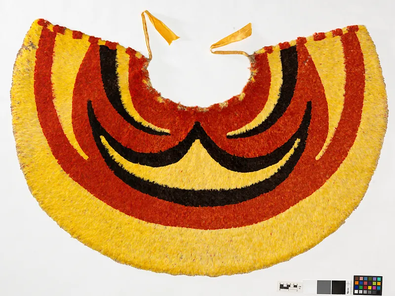 Red, gold, and black cape made from Hawaiian bird feathers