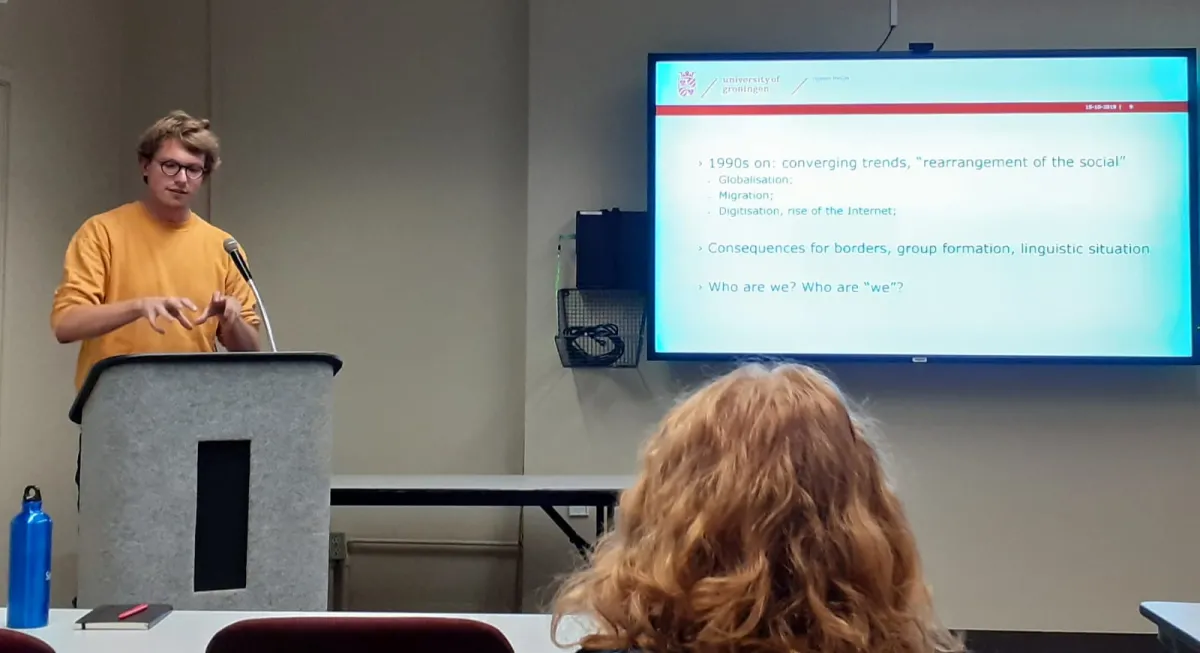Man giving a presentation standing around a podium.