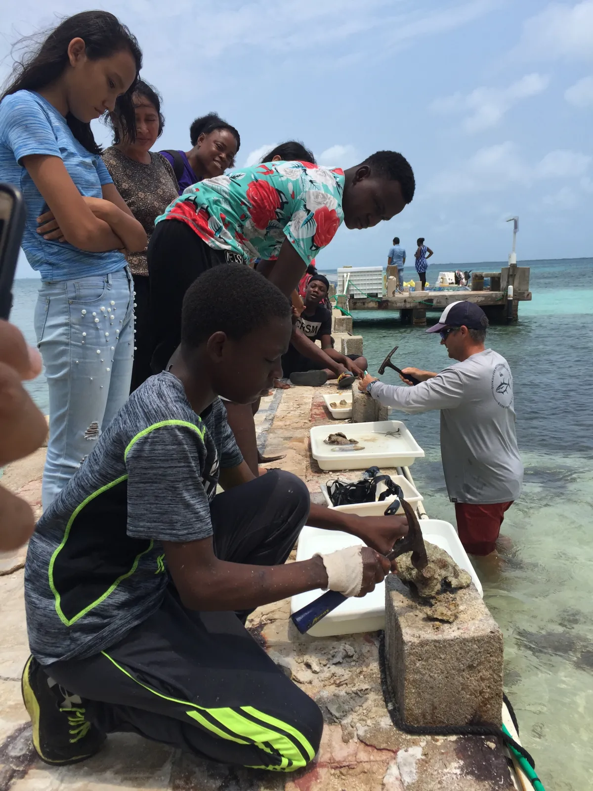 Kids examining conch shells.