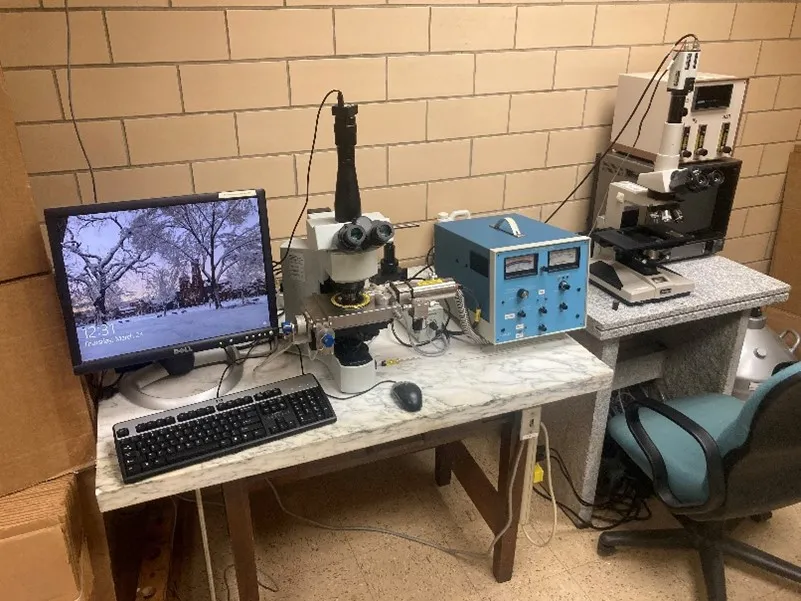 Computer, microscope, and luminoscope in beige-bricked lab