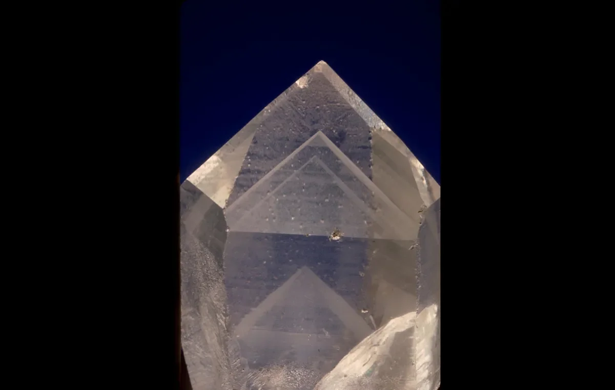 Clear, white quartz crystal with hexagonal pencil shape.