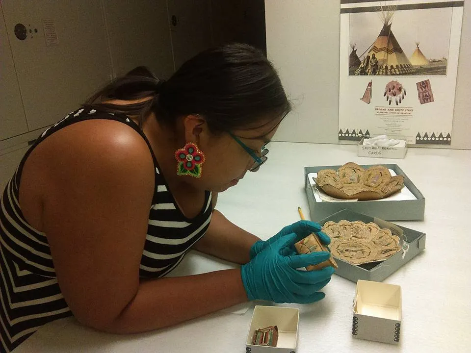 SIMA student examining birchbark baskets