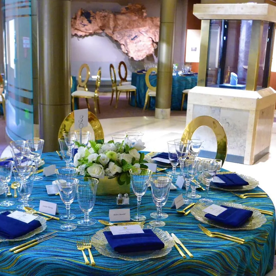 Formal dinner set-up with blue tablecloth and napkins in the Hope Diamond room