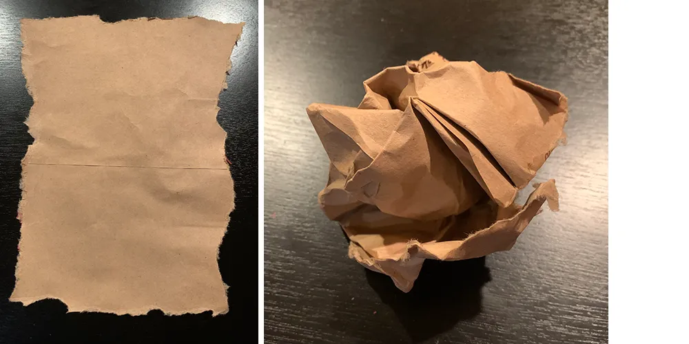 A rectangle of brown butcher paper with jagged, torn edges, next to a crumpled up ball of the same paper.