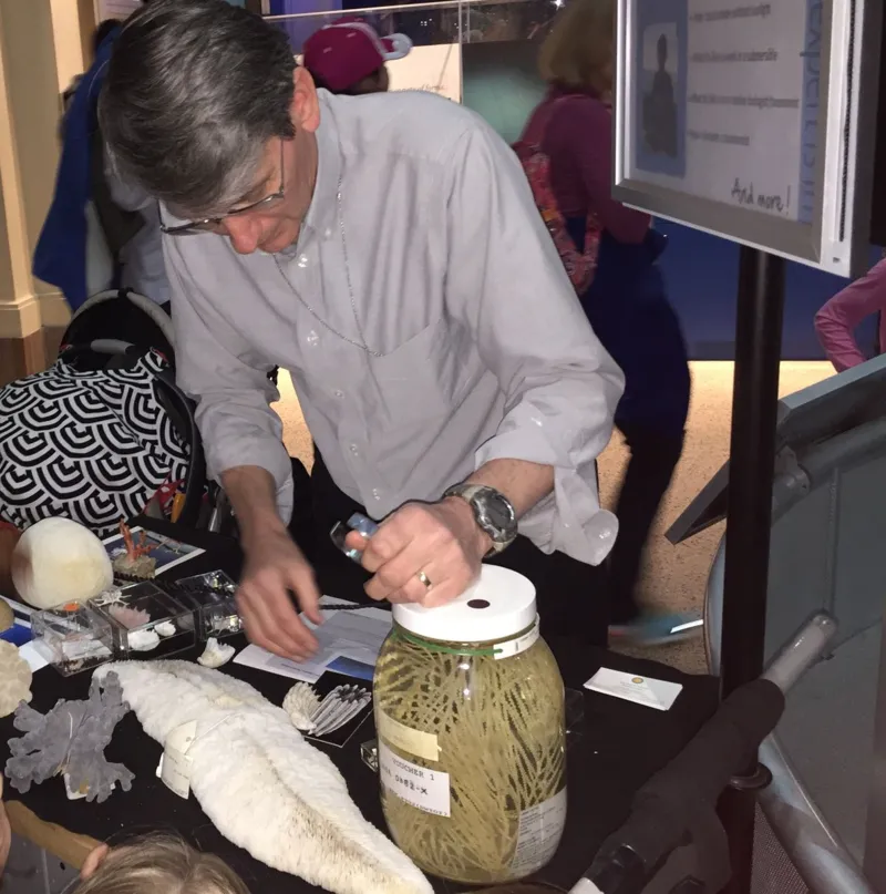 Emeritus zoologist Steve Cairns in the Ocean Hall with coral specimens