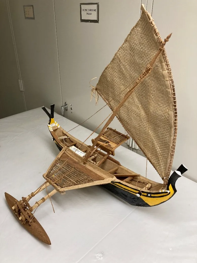 A model outrigger sailing canoe.
