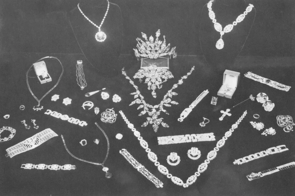 A collection of bracelets, necklaces, and earrings on a black backdrop